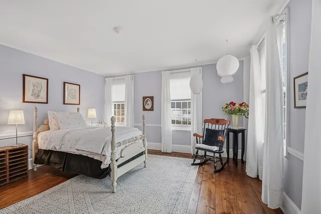 a bed room with a bed and a chair