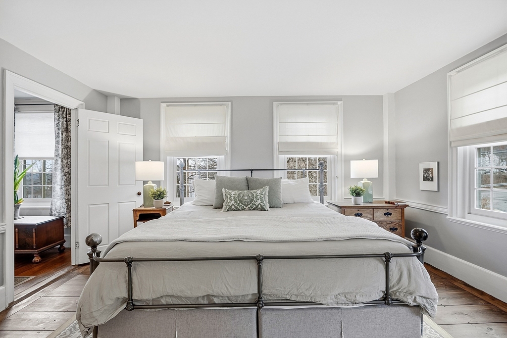 100 Main Street Ashburnham, MA 01430 - Photo 19 of 42 a bedroom with a bed a table and windows