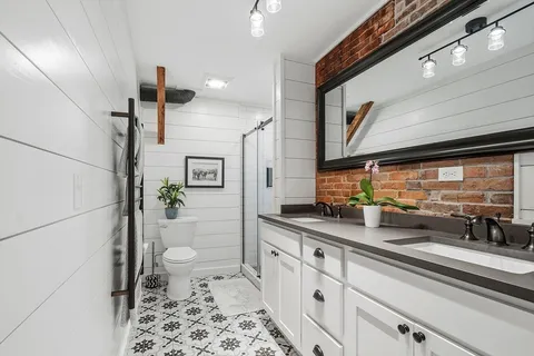 a kitchen with stainless steel appliances a sink a stove and a refrigerator