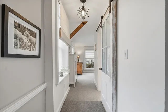 a view of a hallway with paintings on the wall