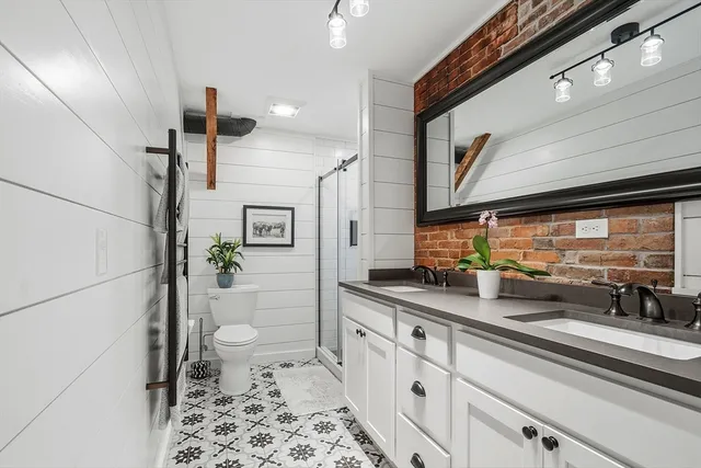 a kitchen with stainless steel appliances a sink a stove and a refrigerator