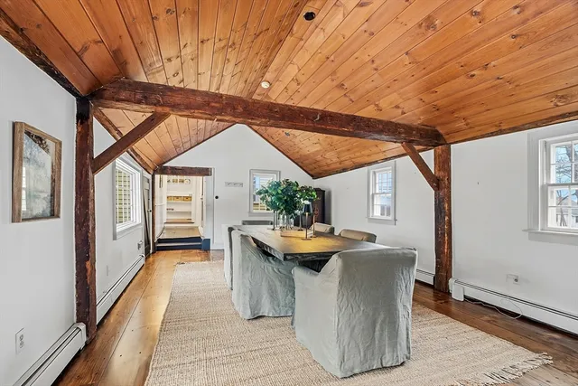 a dining room with furniture and wooden floor
