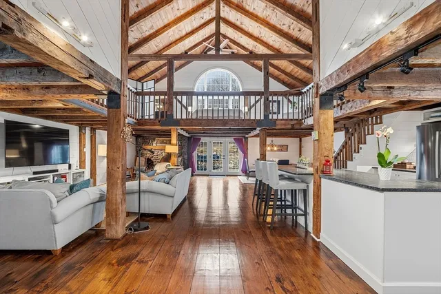 a view of a living room and dining room with wooden floor