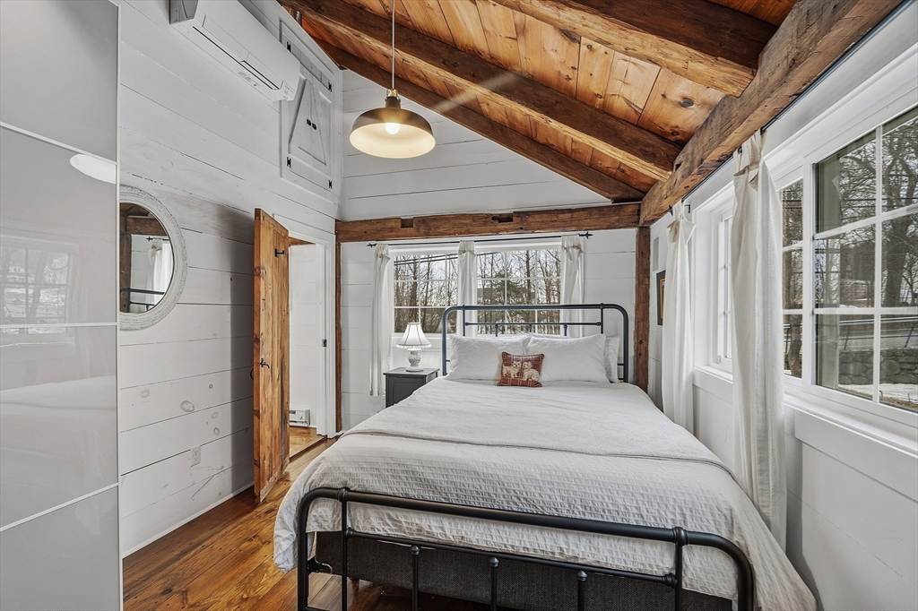 100 Main Street Ashburnham, MA 01430 - Photo 33 of 42 a bedroom with a bed mirror and a large window