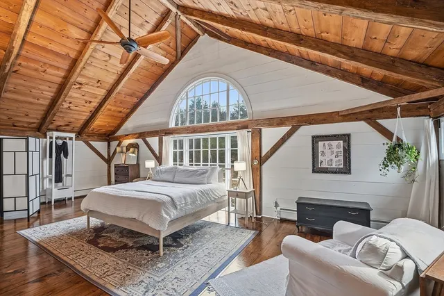 a living room with a couch a rug and a fireplace