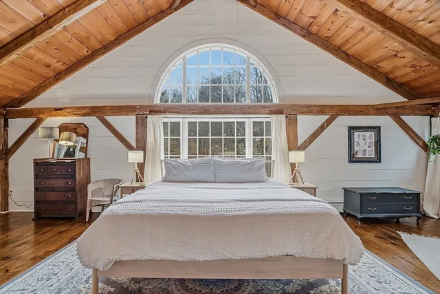 a bedroom with a bed and a view of closet