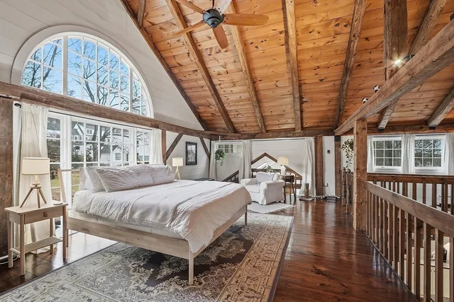 a room with a bed a table and chairs