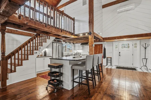 a view of entryway and hall with wooden floor