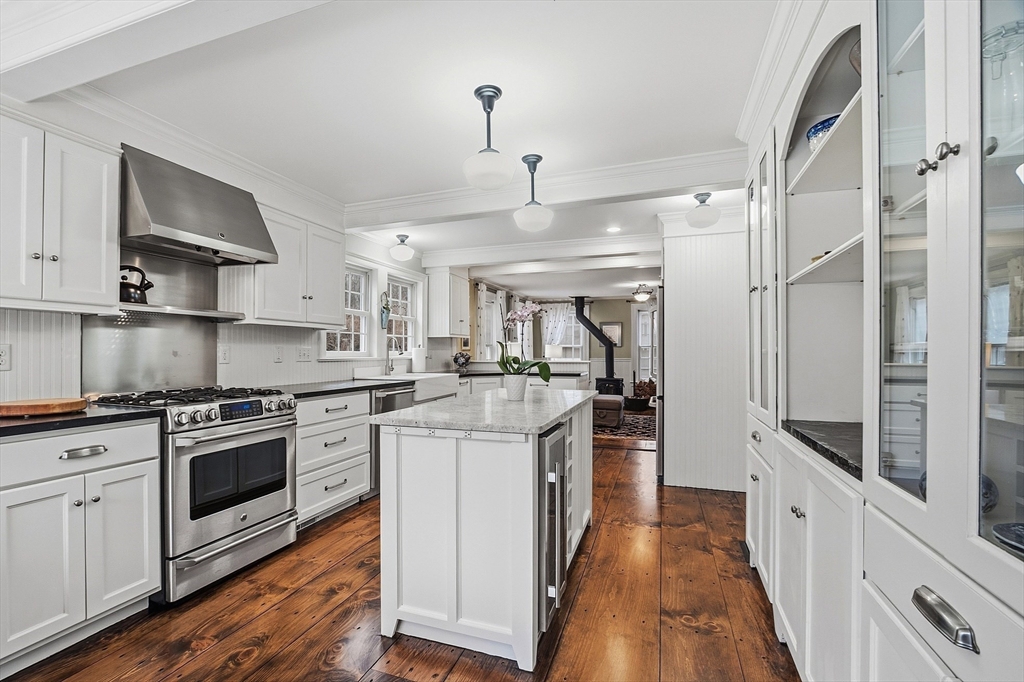 100 Main Street Ashburnham, MA 01430 - Photo 10 of 42 a kitchen with stainless steel appliances granite countertop a stove and white cabinets