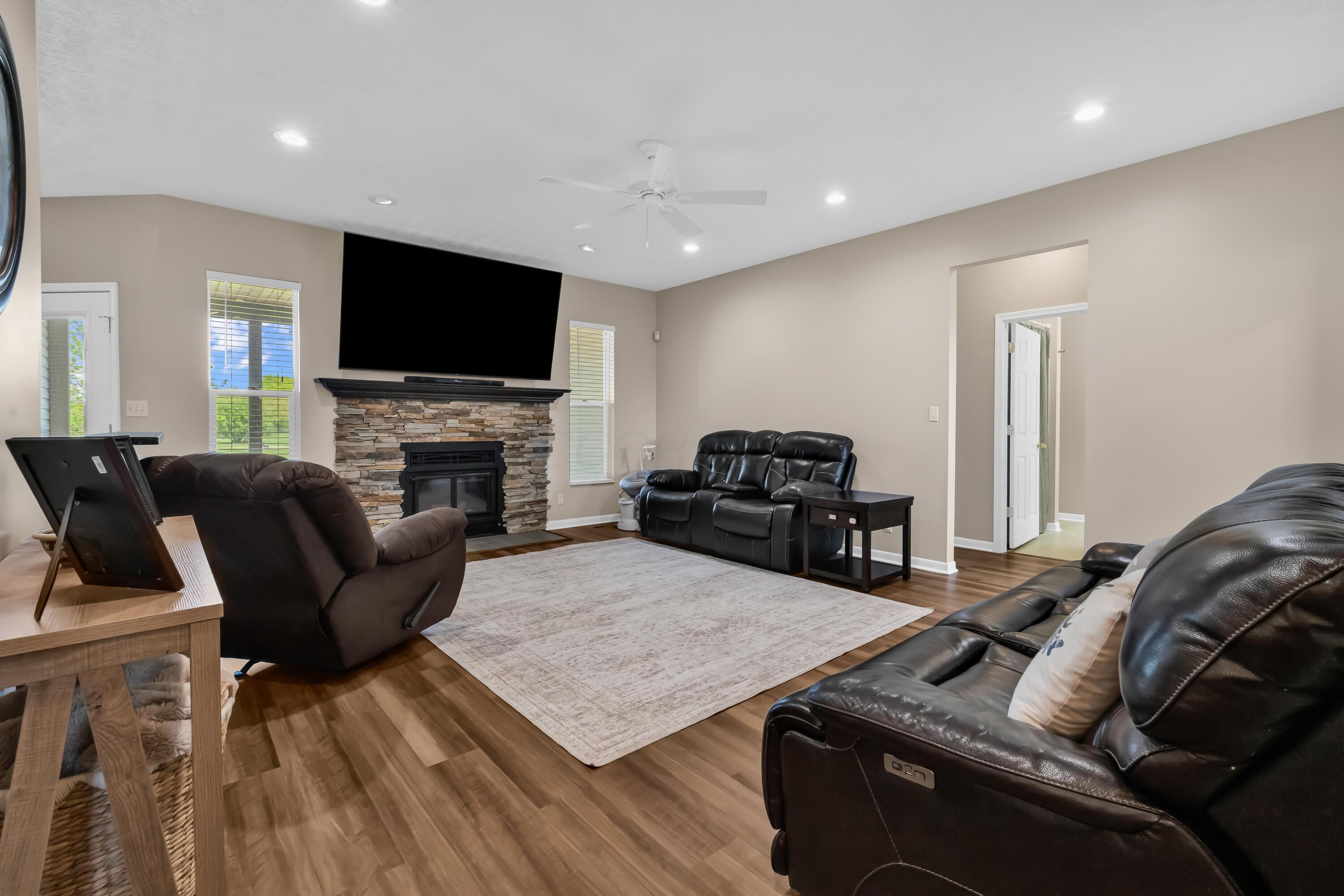 14396 Blamer Road Johnstown, OH 43031 - Photo 9 of 48 • New luxury vinyl plank
flooring ~ 2026
• Tan painted walls
• Can lighting
• Ceiling fan
• Stacked, stone fireplace
with mantle & woodburning
stove insert
• 2” blinds