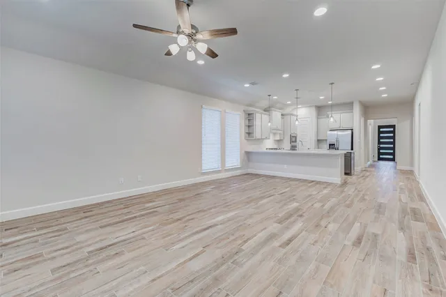 a view of a kitchen with a dishwasher cabinets and wooden floor