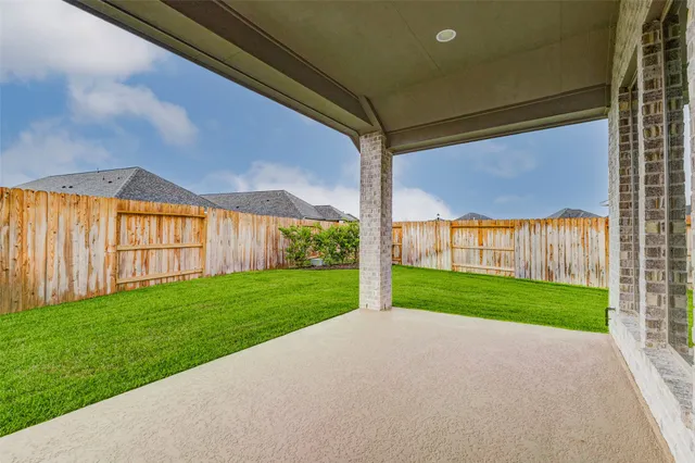a view of a backyard with wooden fence