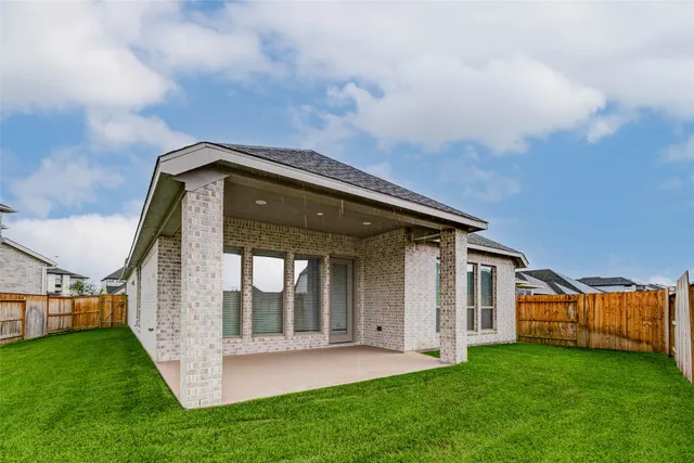 a view of a house with backyard and porch