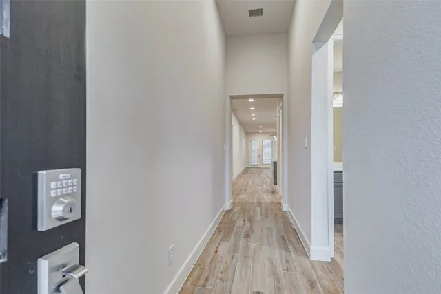 a view of a hallway with wooden floor