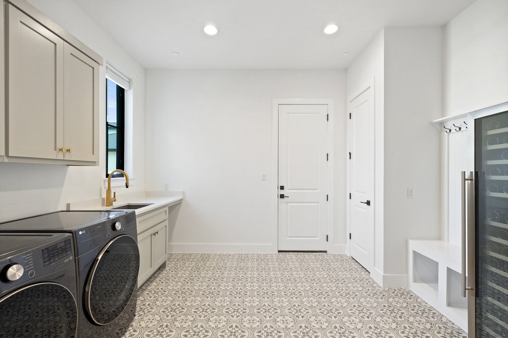 7516 Davenport Divide Road Austin, TX 78738 - Photo 23 of 40 The laundry room is ultra-functional with a sink, storage, and a built-in drop zone.