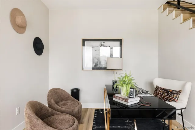 a work room with furniture and a potted plant