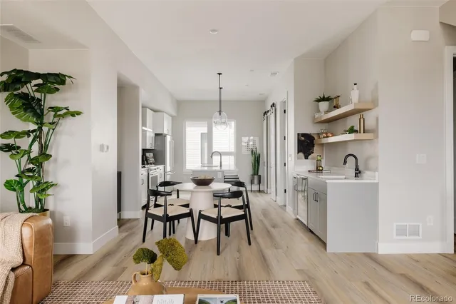 a living room with furniture and a dining table with wooden floor