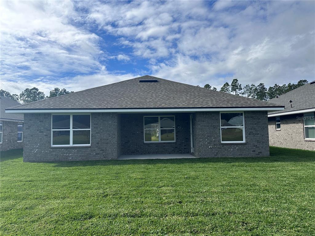 90 Rivertown Road Palm Coast, FL 32137 - Photo 28 of 60 a front view of a house with a garden