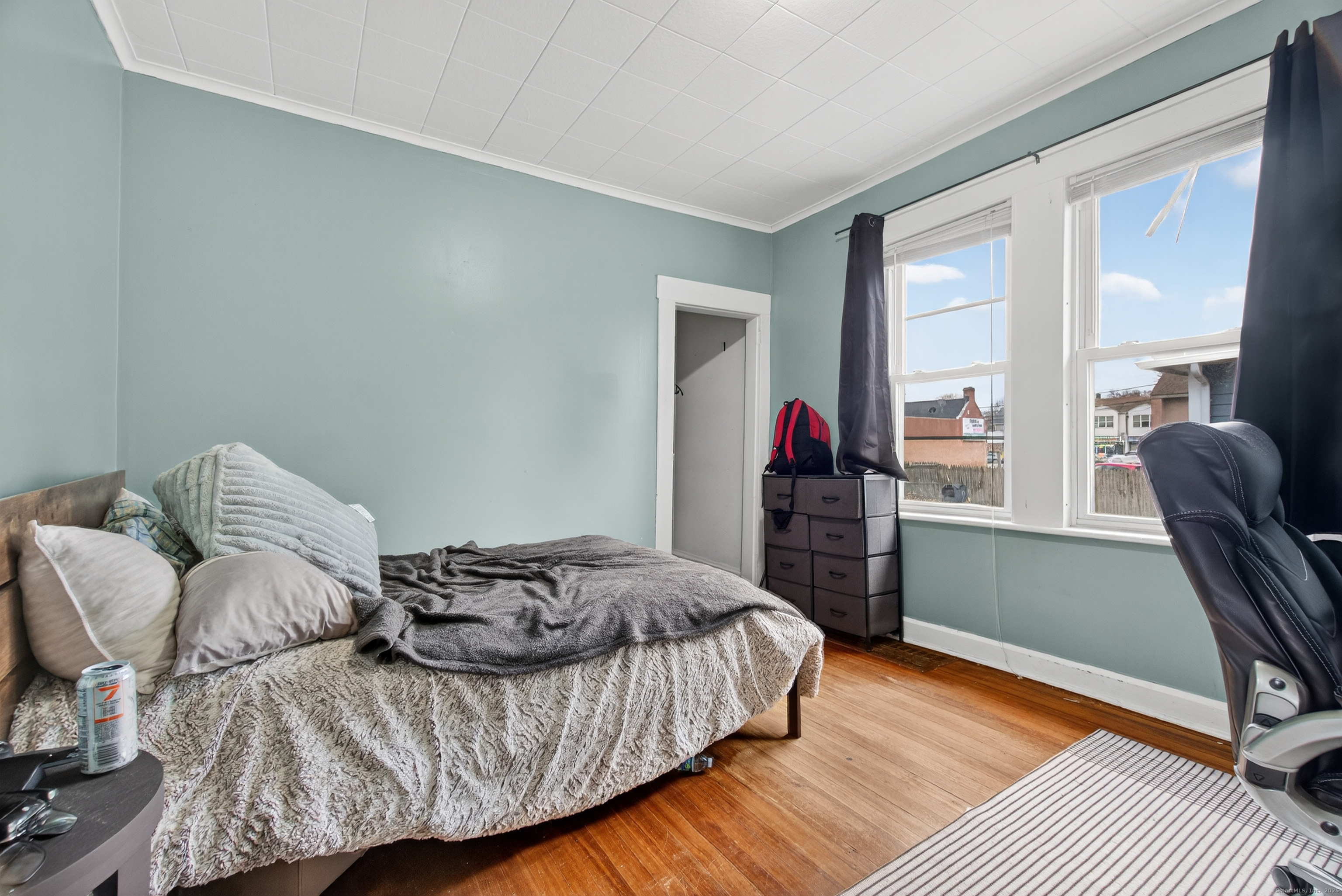 215 Overland Avenue Bridgeport, CT 06606 - Photo 13 of 32 a bedroom with a bed and wooden floor