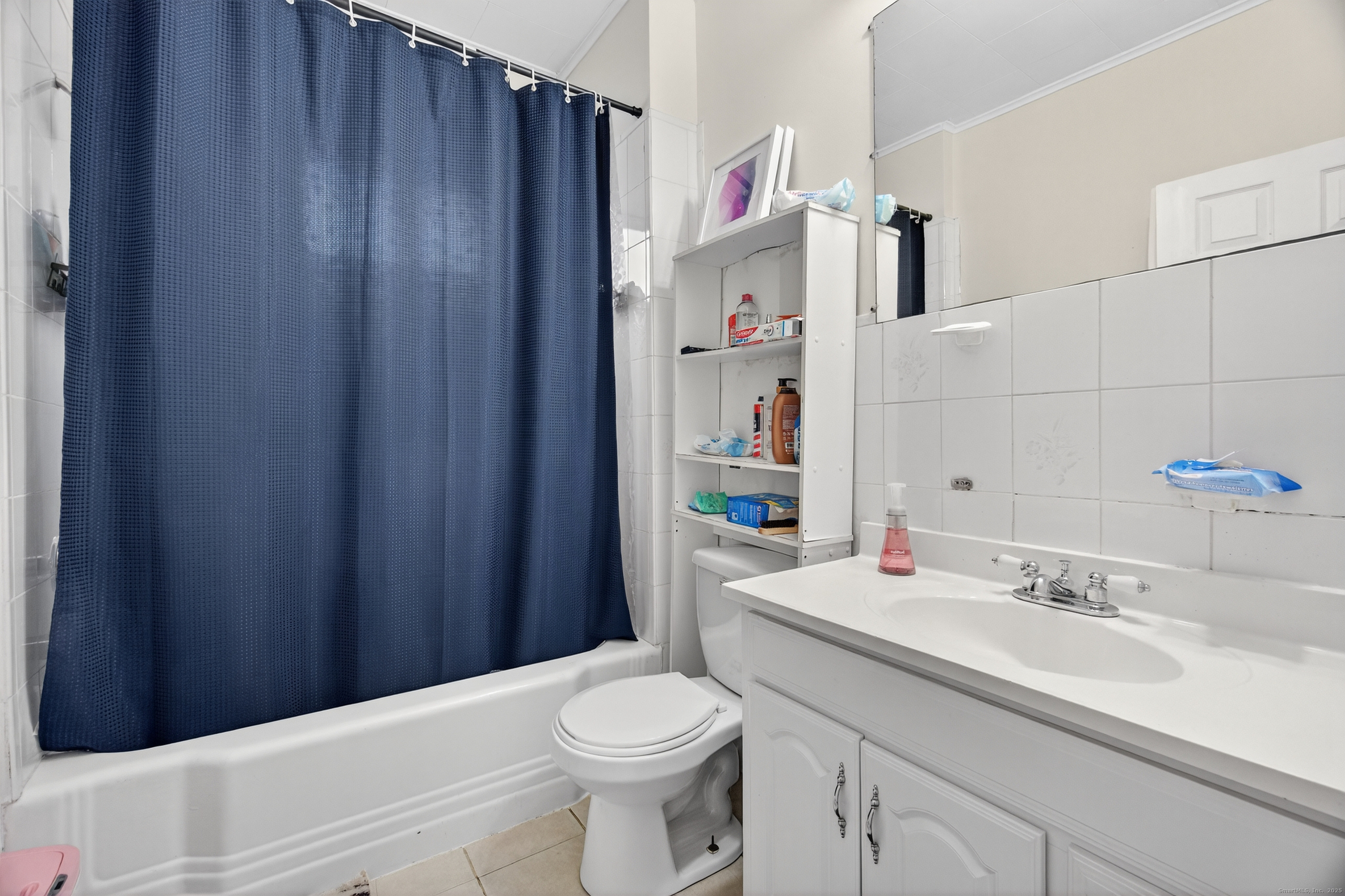 215 Overland Avenue Bridgeport, CT 06606 - Photo 15 of 32 a bathroom with a sink a toilet and shower curtain