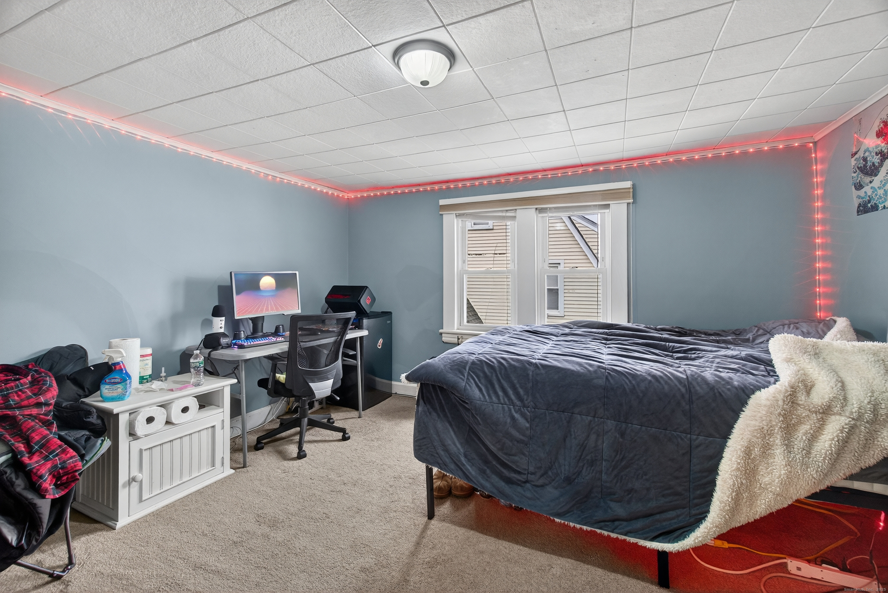 215 Overland Avenue Bridgeport, CT 06606 - Photo 20 of 32 a bedroom with a bed and a chandelier