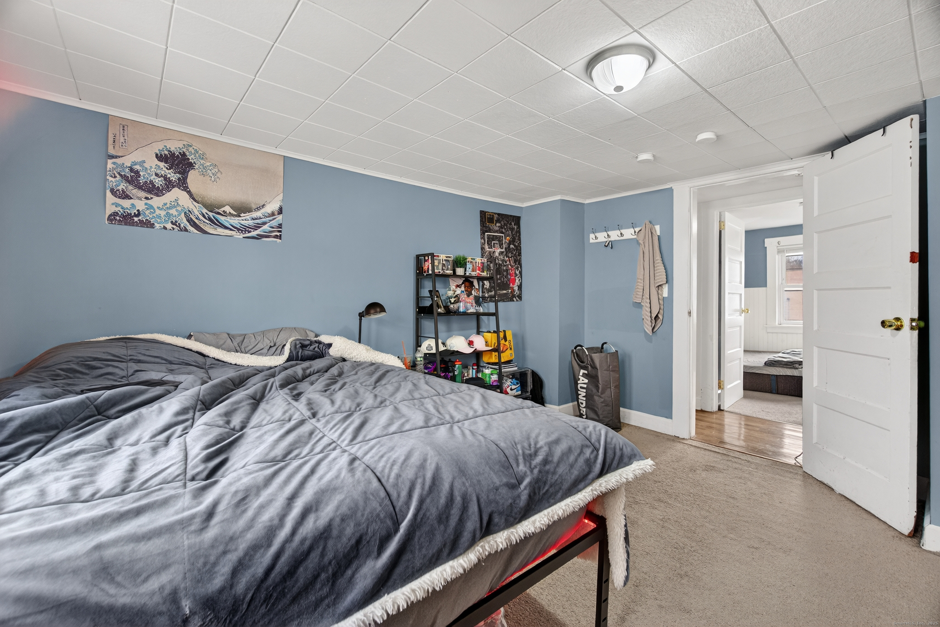 215 Overland Avenue Bridgeport, CT 06606 - Photo 21 of 32 a bed room with a bed and a large mirror