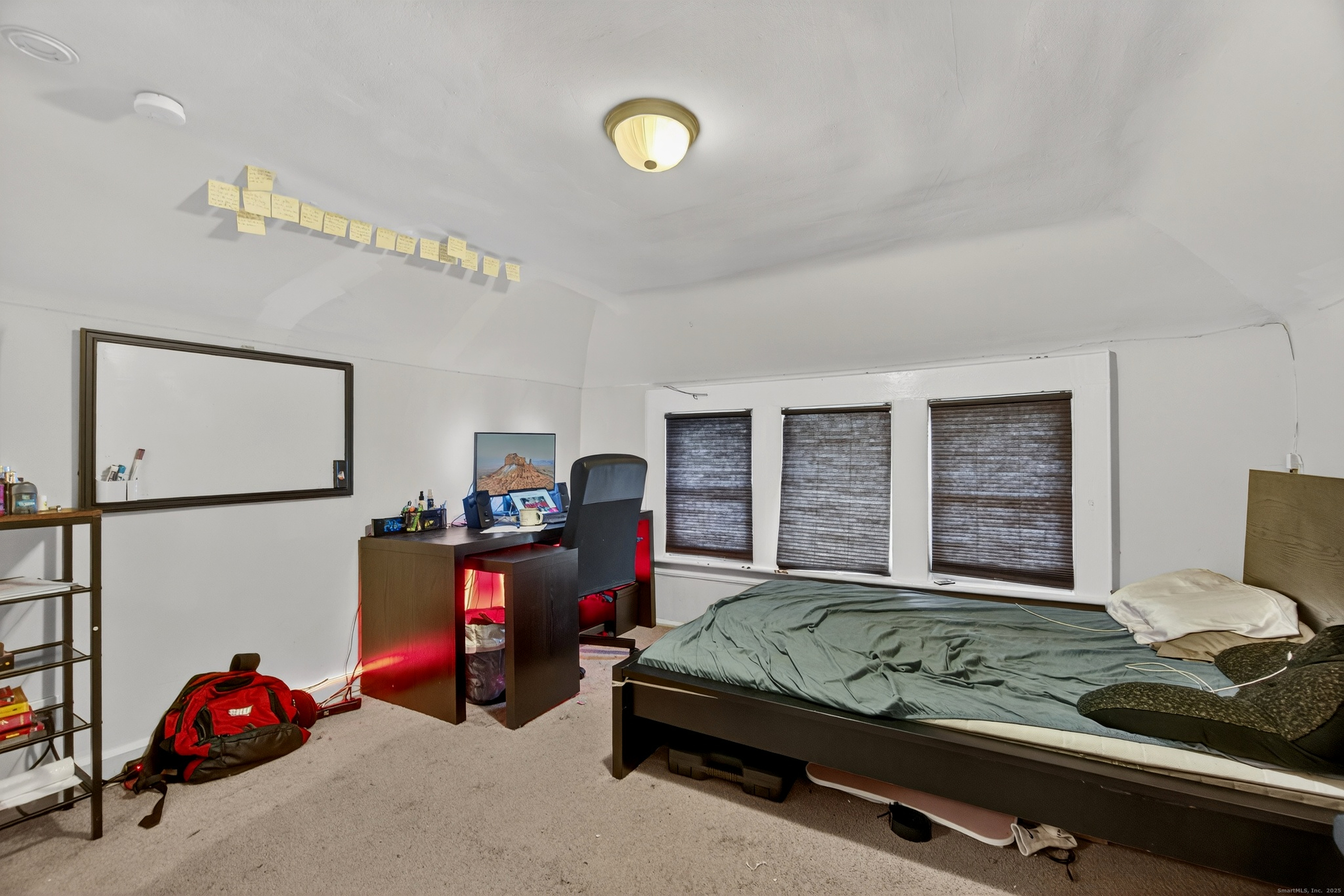 215 Overland Avenue Bridgeport, CT 06606 - Photo 22 of 32 a bedroom with a bed and a chandelier