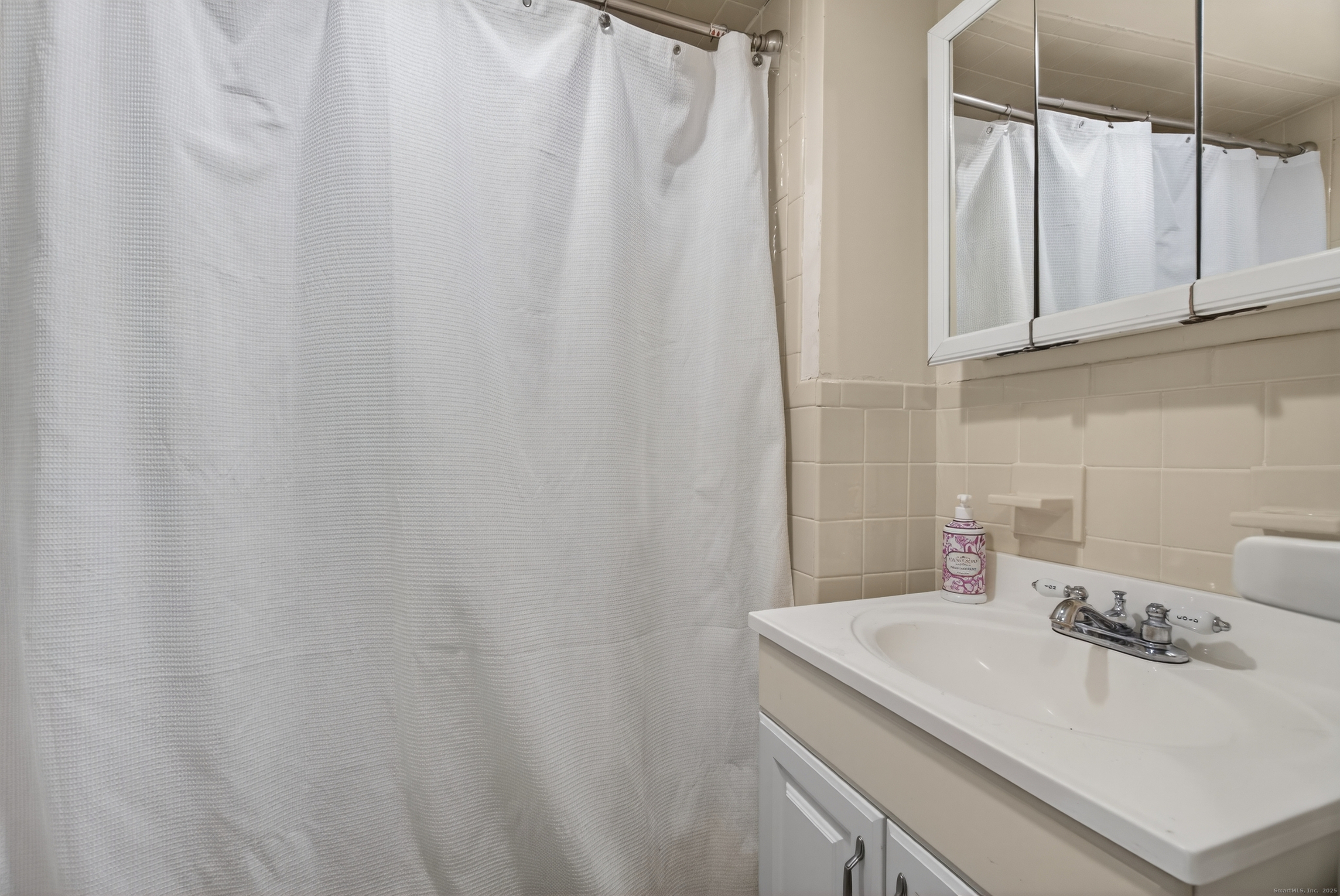 215 Overland Avenue Bridgeport, CT 06606 - Photo 23 of 32 a bathroom with a sink and a mirror