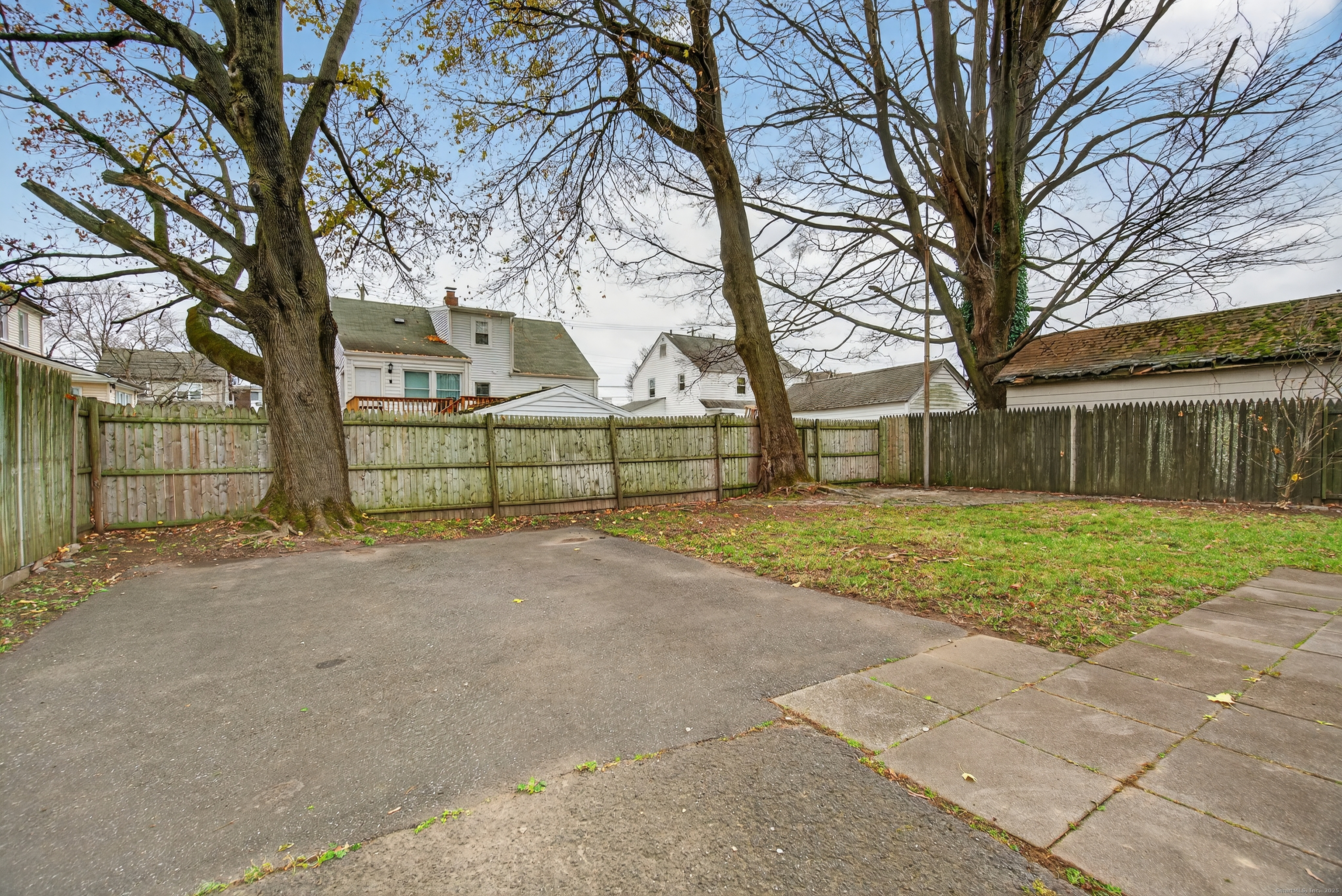 215 Overland Avenue Bridgeport, CT 06606 - Photo 24 of 32 a view of a white house with a large road next to a yard