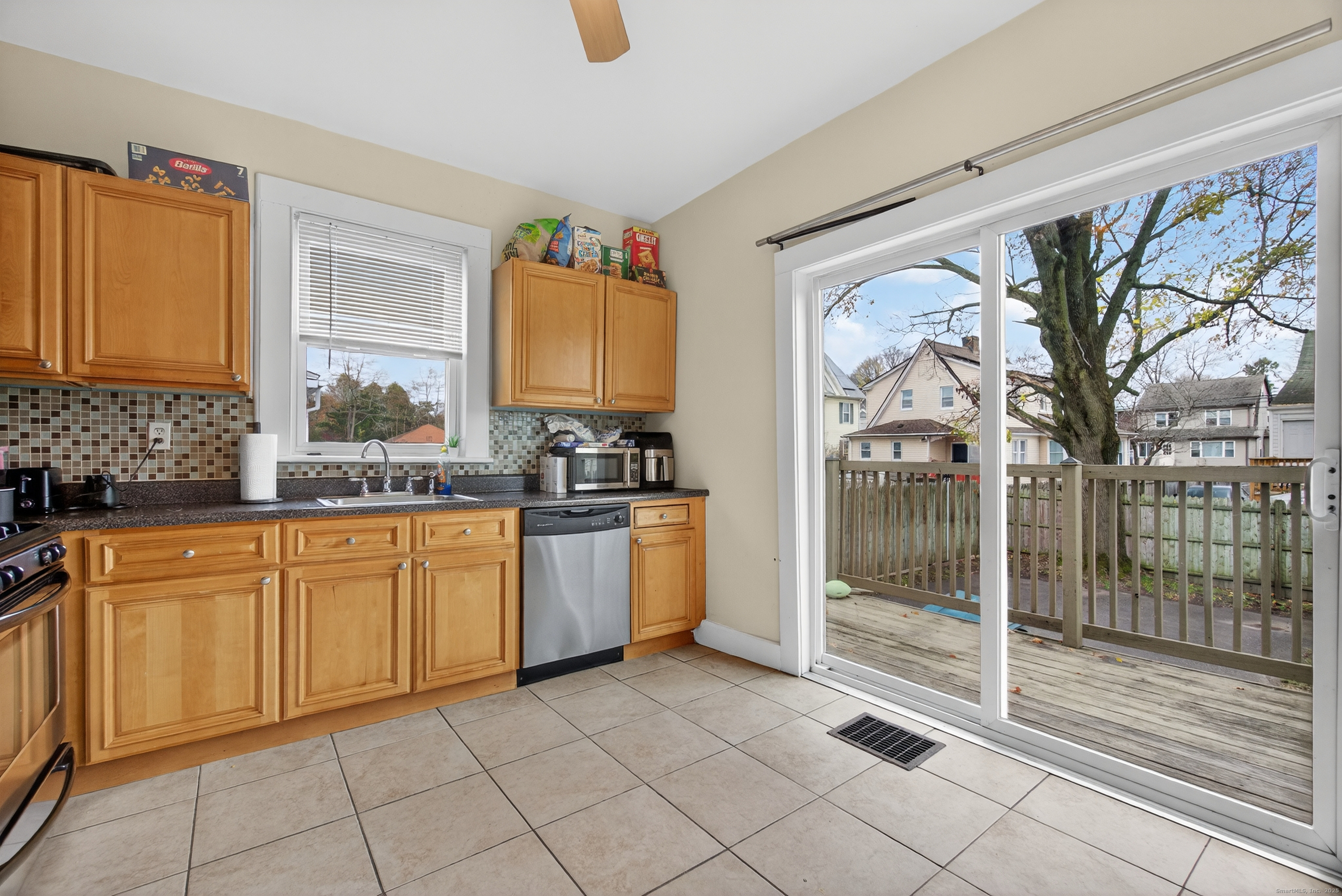 215 Overland Avenue Bridgeport, CT 06606 - Photo 9 of 32 a kitchen with stainless steel appliances granite countertop a stove a sink and a refrigerator