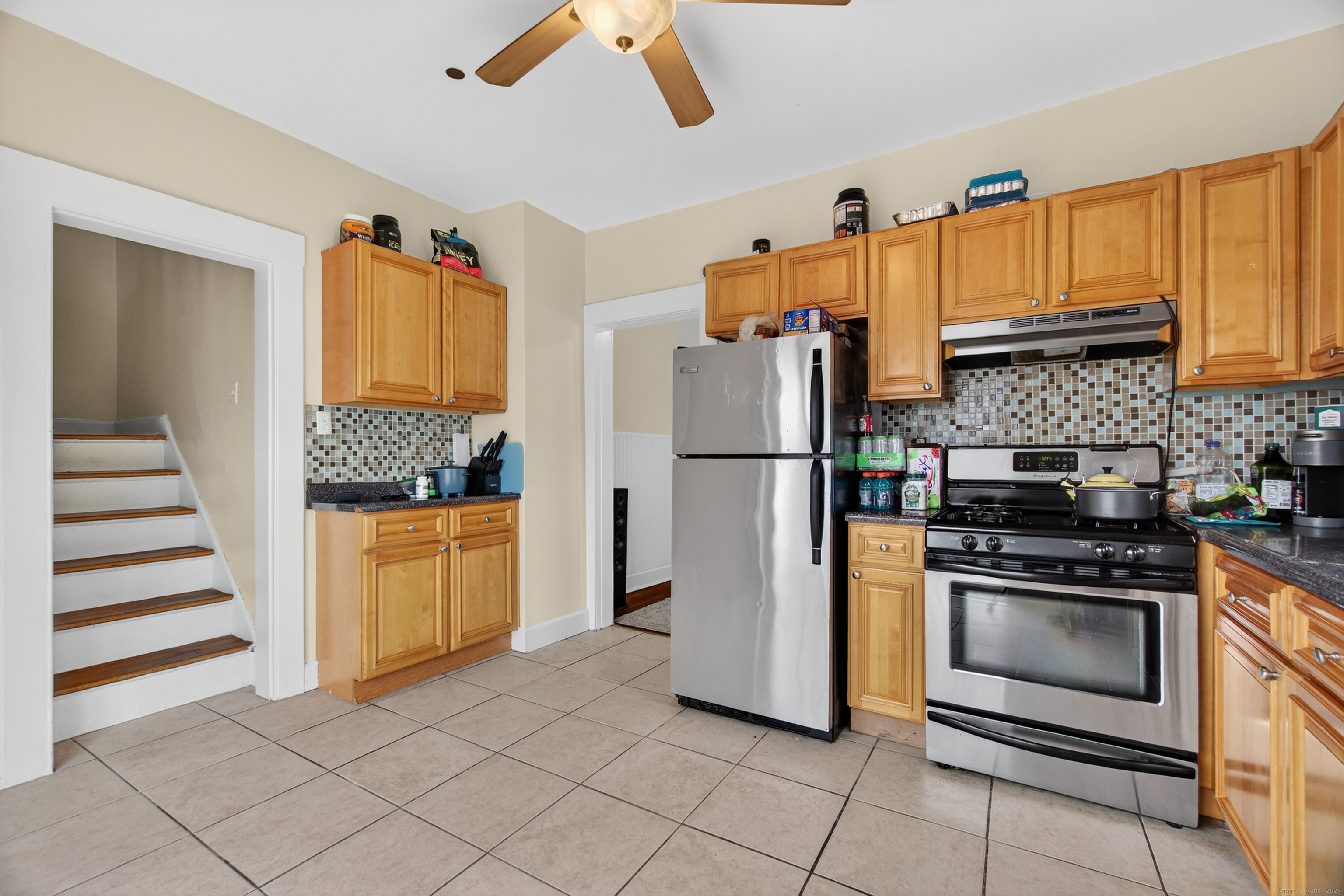 215 Overland Avenue Bridgeport, CT 06606 - Photo 10 of 32 a kitchen with a refrigerator and a stove