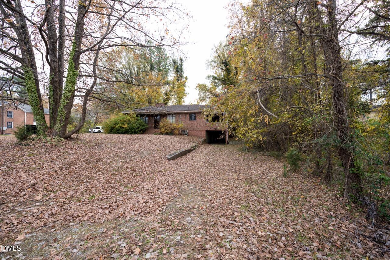 2328 Cheek Road Durham, NC 27704 - Photo 6 of 7 a view of a house with a yard and tree s