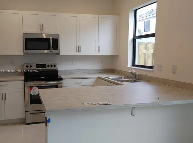 a kitchen with a sink and cabinets