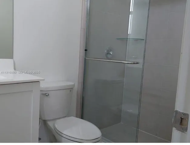 a white toilet sitting next to a bathroom sink