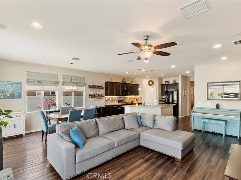 1580 Williamson Park Beaumont, CA 92223 - Photo 18 of 48 a living room with furniture kitchen view and a chandelier