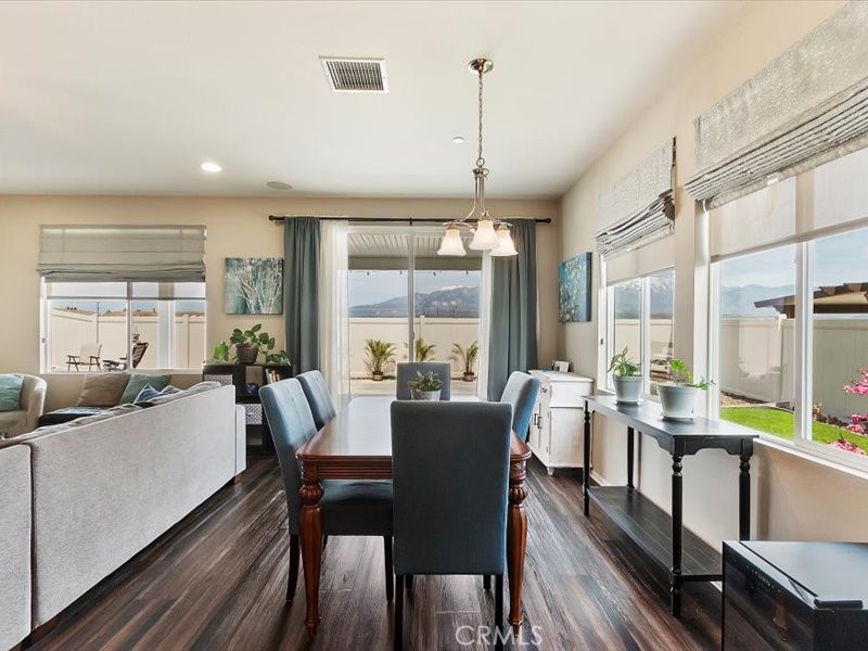1580 Williamson Park Beaumont, CA 92223 - Photo 20 of 48 a view of a dining room with furniture large windows and wooden floor