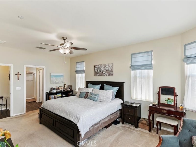 1580 Williamson Park Beaumont, CA 92223 - Photo 23 of 48 a bedroom with a bed and a chandelier