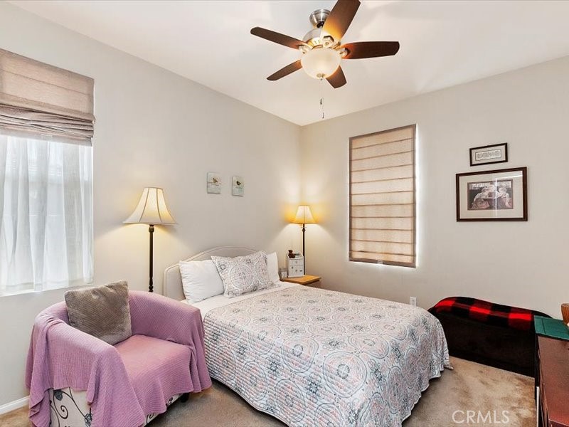 1580 Williamson Park Beaumont, CA 92223 - Photo 28 of 48 a bedroom with a bed and a chandelier