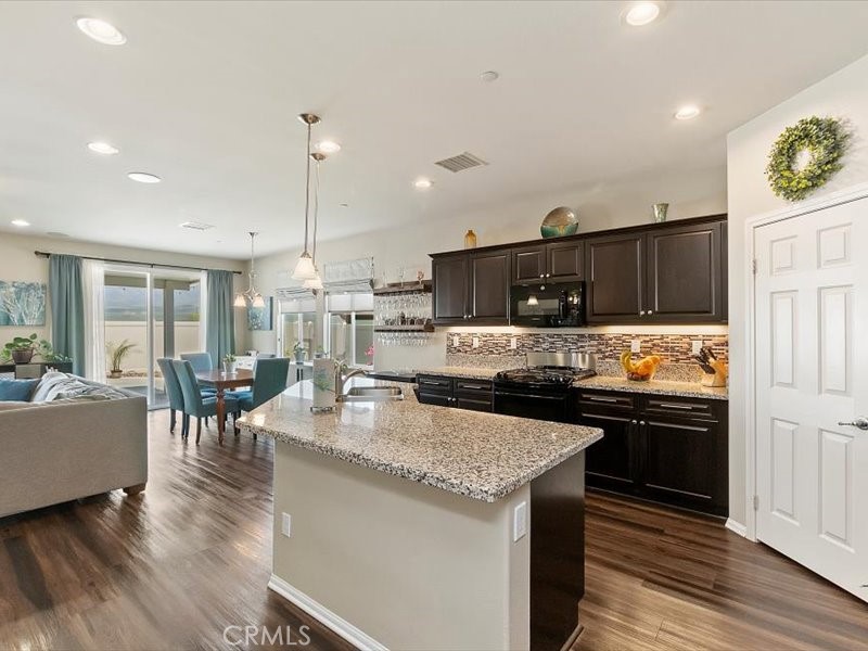 1580 Williamson Park Beaumont, CA 92223 - Photo 6 of 48 a kitchen with granite countertop a stove and cabinets