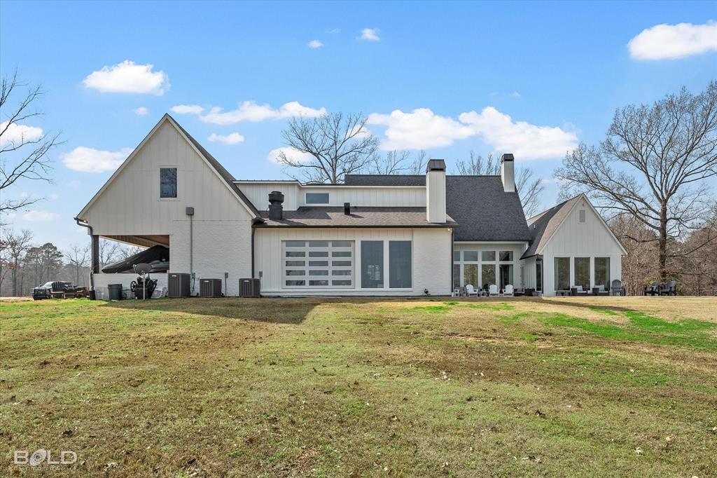 5296 Linton Cutoff Road Benton, LA 71006 - Photo 13 of 40 Back of house featuring a chimney and a lawn