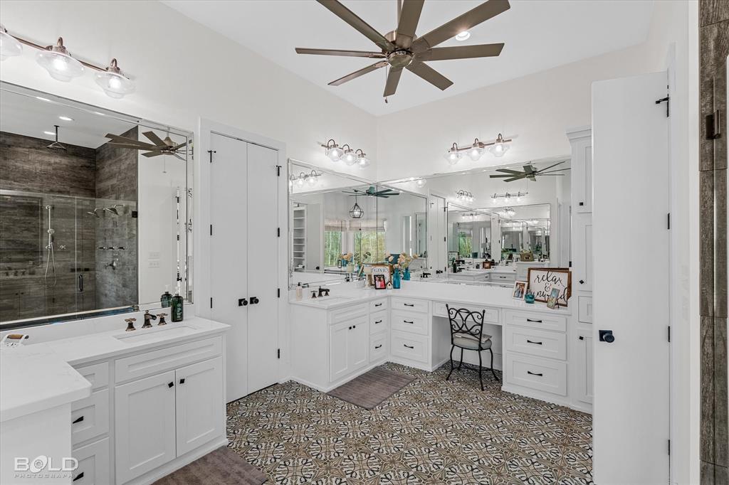5296 Linton Cutoff Road Benton, LA 71006 - Photo 27 of 40 Full bathroom with two vanities, a shower stall, ceiling fan, and dark flooring