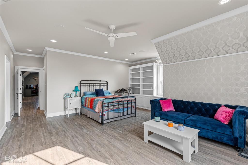 5296 Linton Cutoff Road Benton, LA 71006 - Photo 35 of 40 Bedroom with light wood-style flooring, recessed lighting, ornamental molding, ceiling fan, and an accent wall
