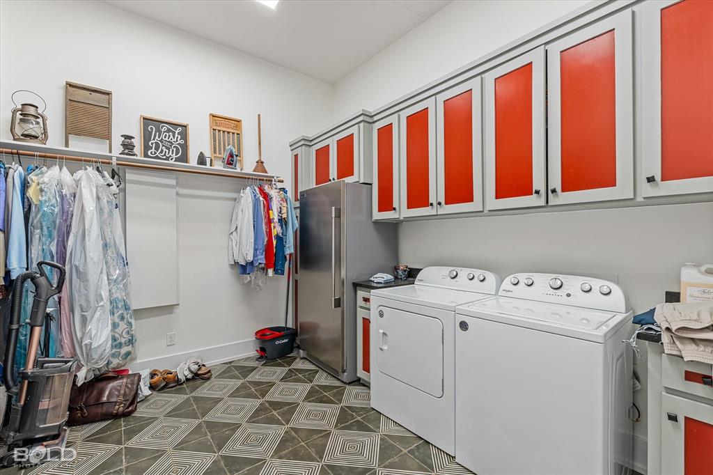 5296 Linton Cutoff Road Benton, LA 71006 - Photo 38 of 40 Laundry area featuring cabinet space, washer and dryer, and dark floors