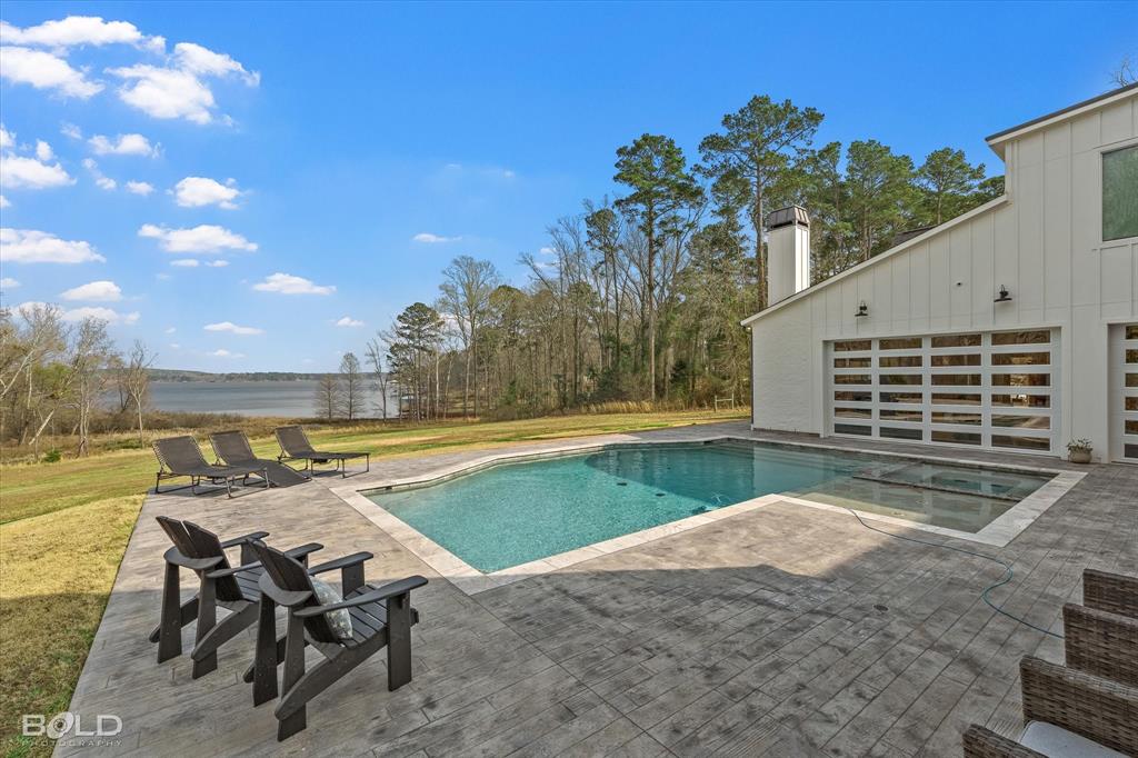 5296 Linton Cutoff Road Benton, LA 71006 - Photo 7 of 40 Combined pool / hot tub with a patio area, a yard, and a water view