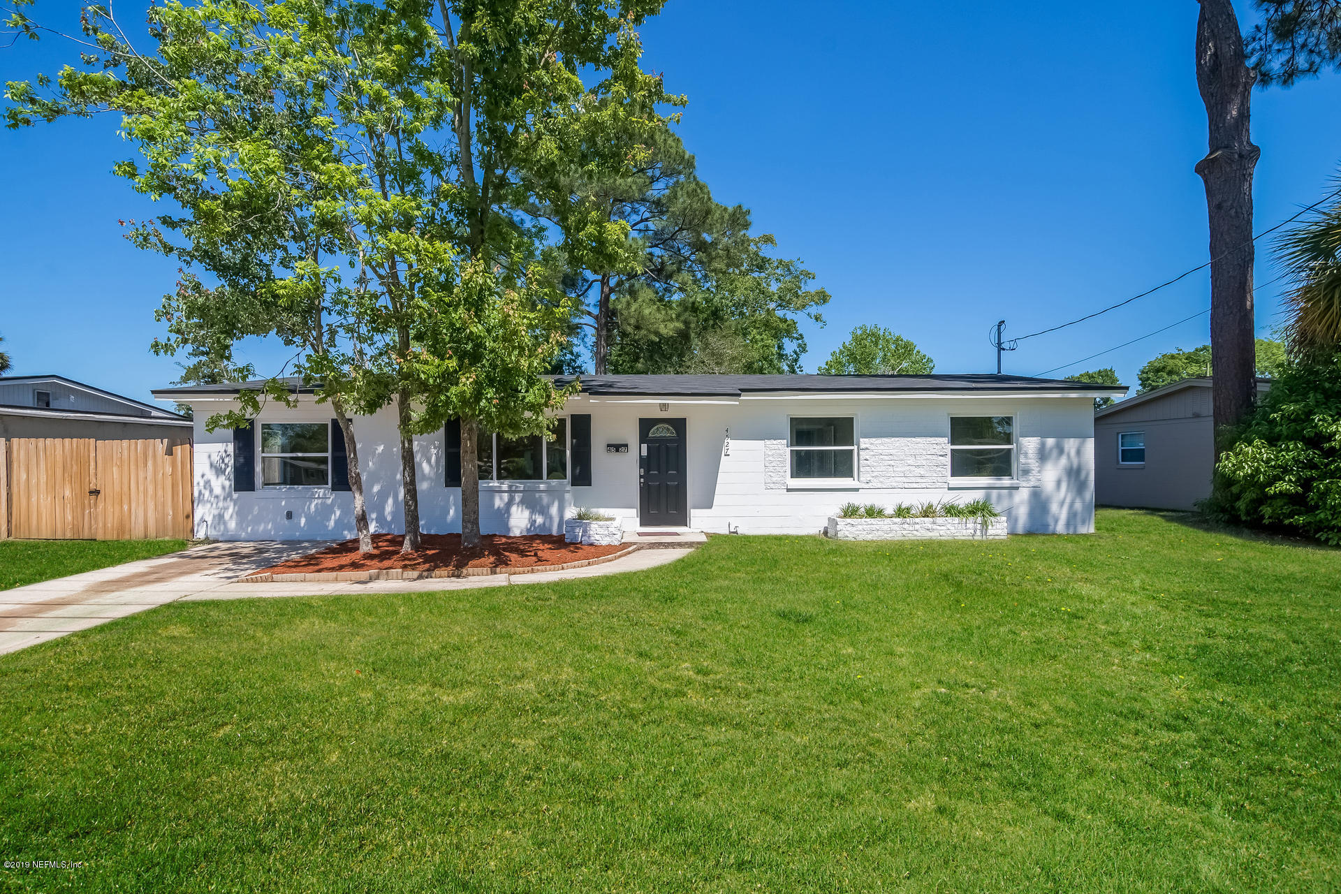 4527 Barnes Road South Jacksonville, FL 32207 - Photo 1 of 25 a front view of a house with a garden and patio