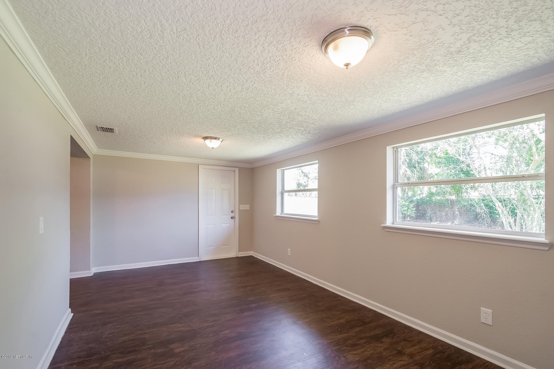 4527 Barnes Road South Jacksonville, FL 32207 - Photo 15 of 25 a view of an empty room with wooden floor and a window
