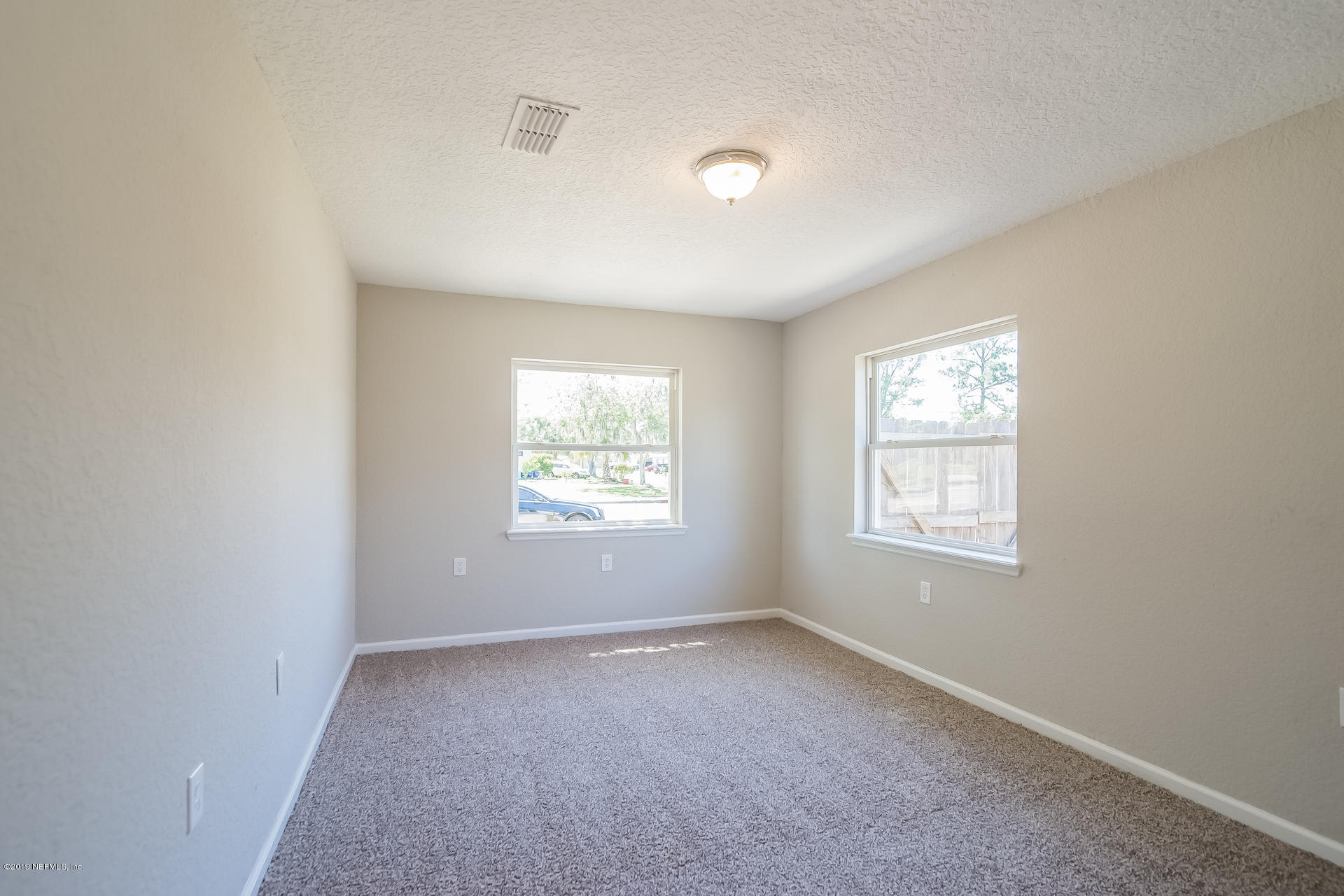 4527 Barnes Road South Jacksonville, FL 32207 - Photo 16 of 25 an empty room with windows