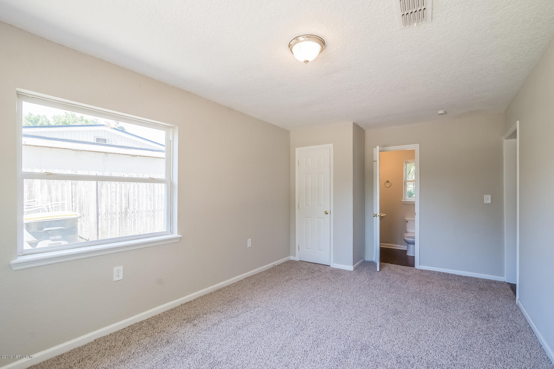 4527 Barnes Road South Jacksonville, FL 32207 - Photo 4 of 25 a view of an empty room with a window