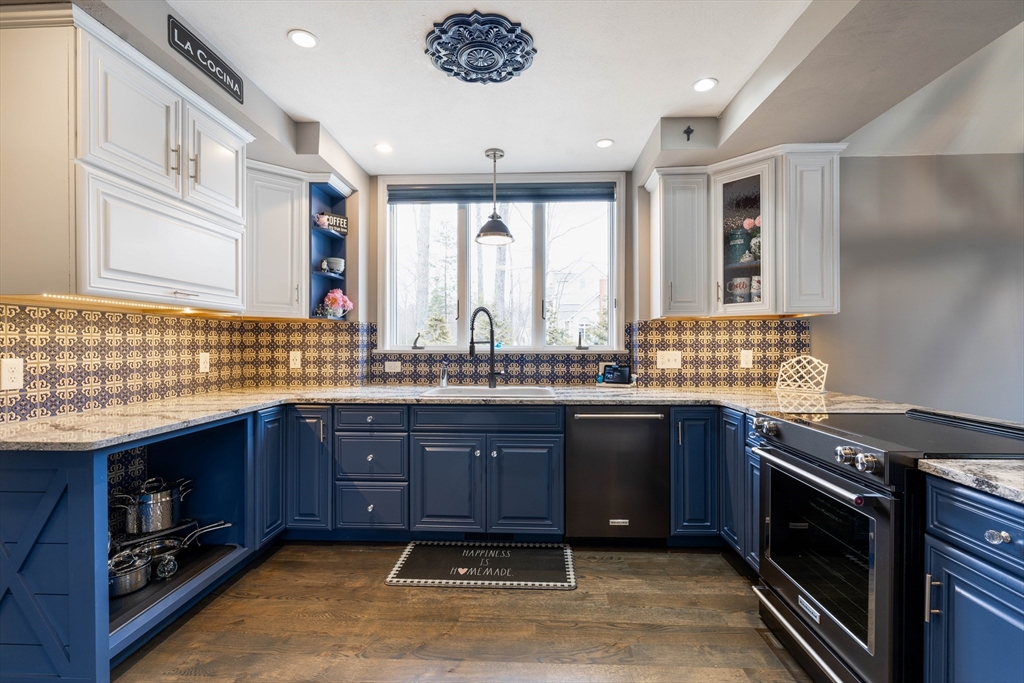 11 Pope Road Atkinson, NH 03811 - Photo 14 of 42 a kitchen with stainless steel appliances granite countertop a sink and stove