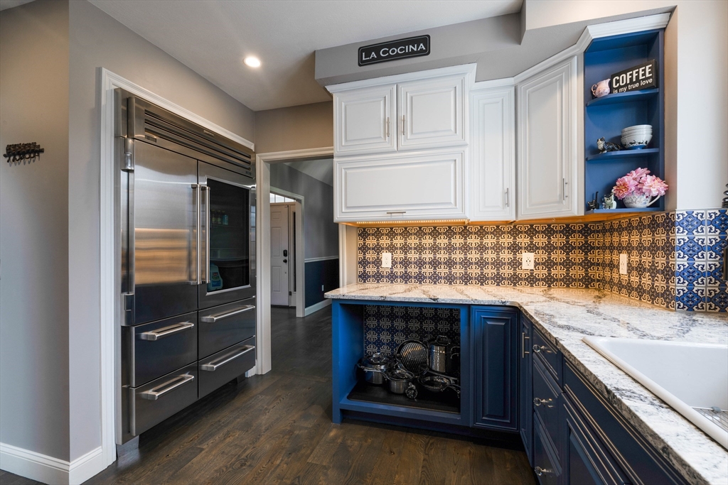 11 Pope Road Atkinson, NH 03811 - Photo 15 of 42 a kitchen with granite countertop wooden cabinets and a stove